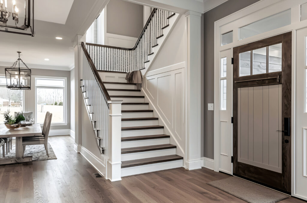 Craftsman entry staircase with box newels and iron balusters