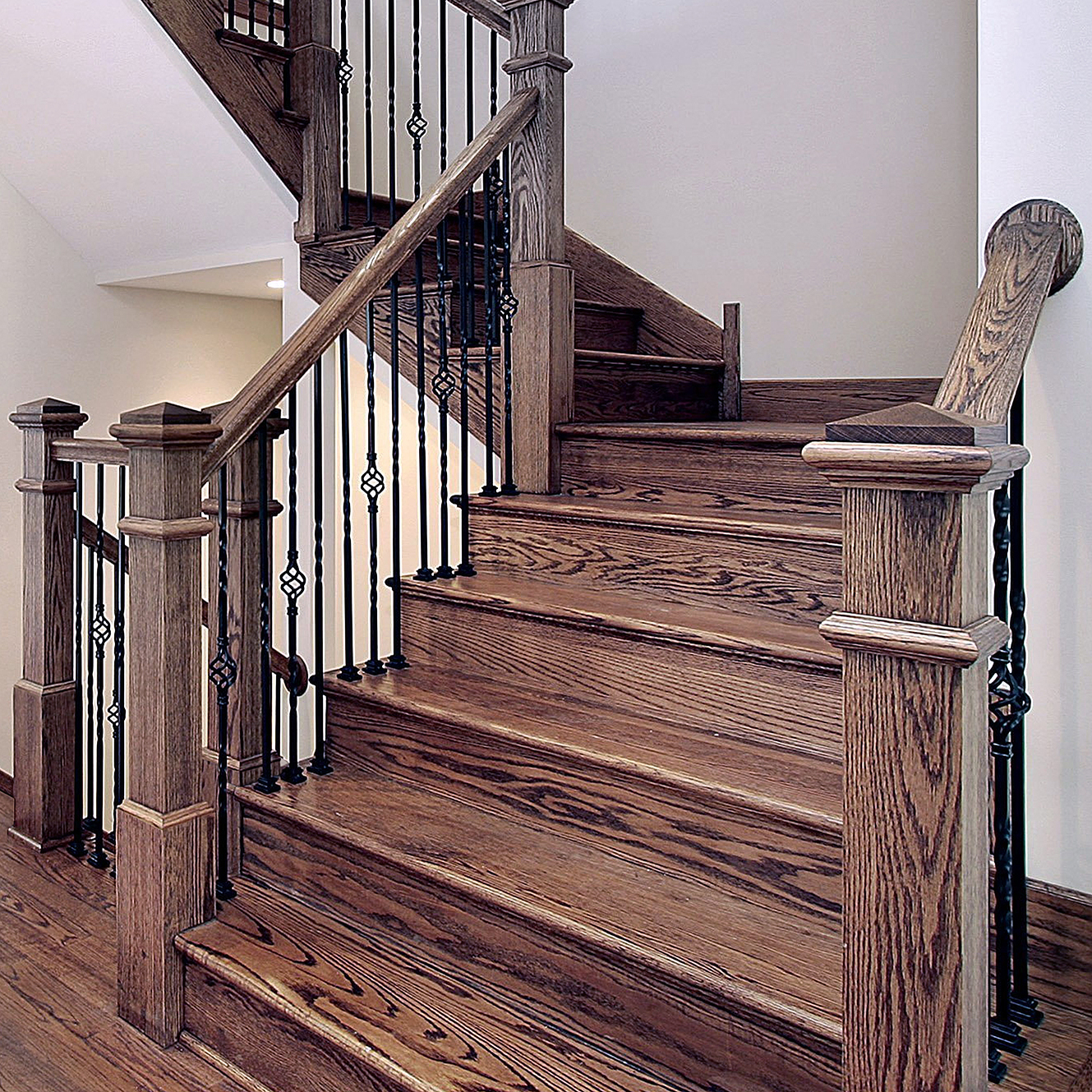 Oak staircase with twisted iron balusters and basket details